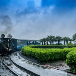 May 01,2017.The Darjeeling Himalayan Railway, also known as the Toy Train, is a 2 ft narrow gauge railway,is entering to the Batasia loop,Darjeeling, west bengal, India. after a heavy rainfall.